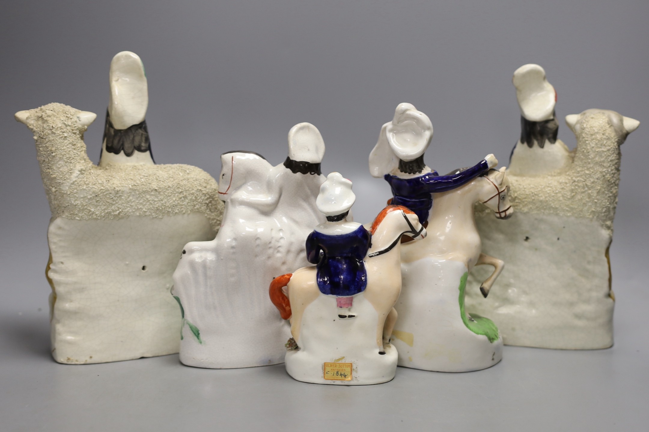 A pair of 19th century Staffordshire sheep and children groups and three Staffordshire pottery and equestrian groups - tallest 22.5cm
